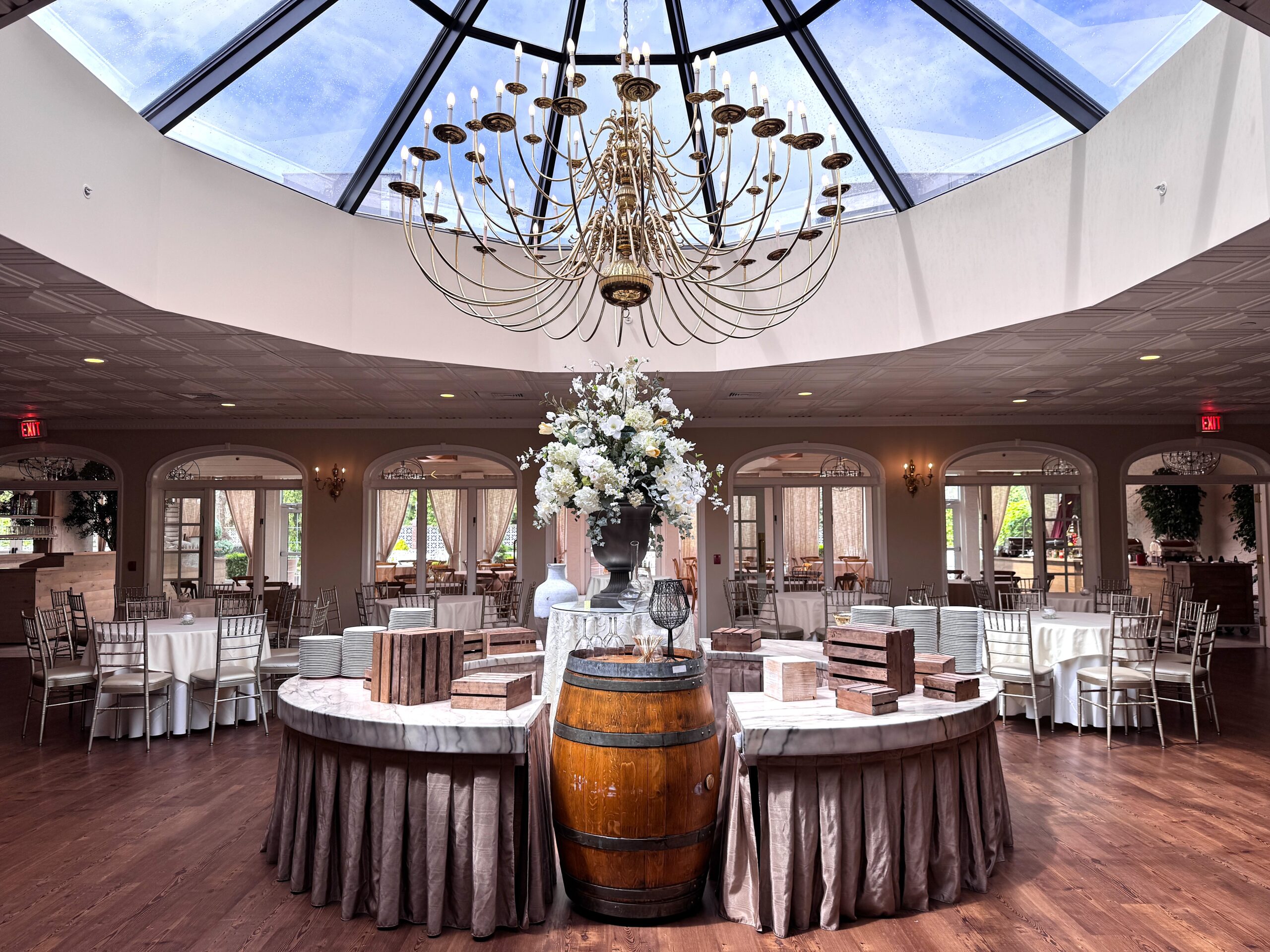 Elegant venue with chandelier and skylight.