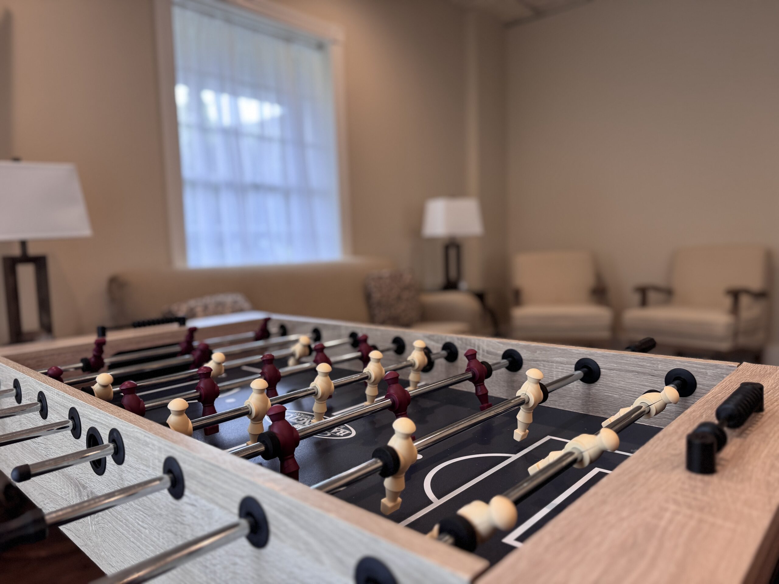 Foosball table in cozy lounge setting.
