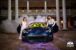 Veranda - Bride and Groom front of hotel with car
