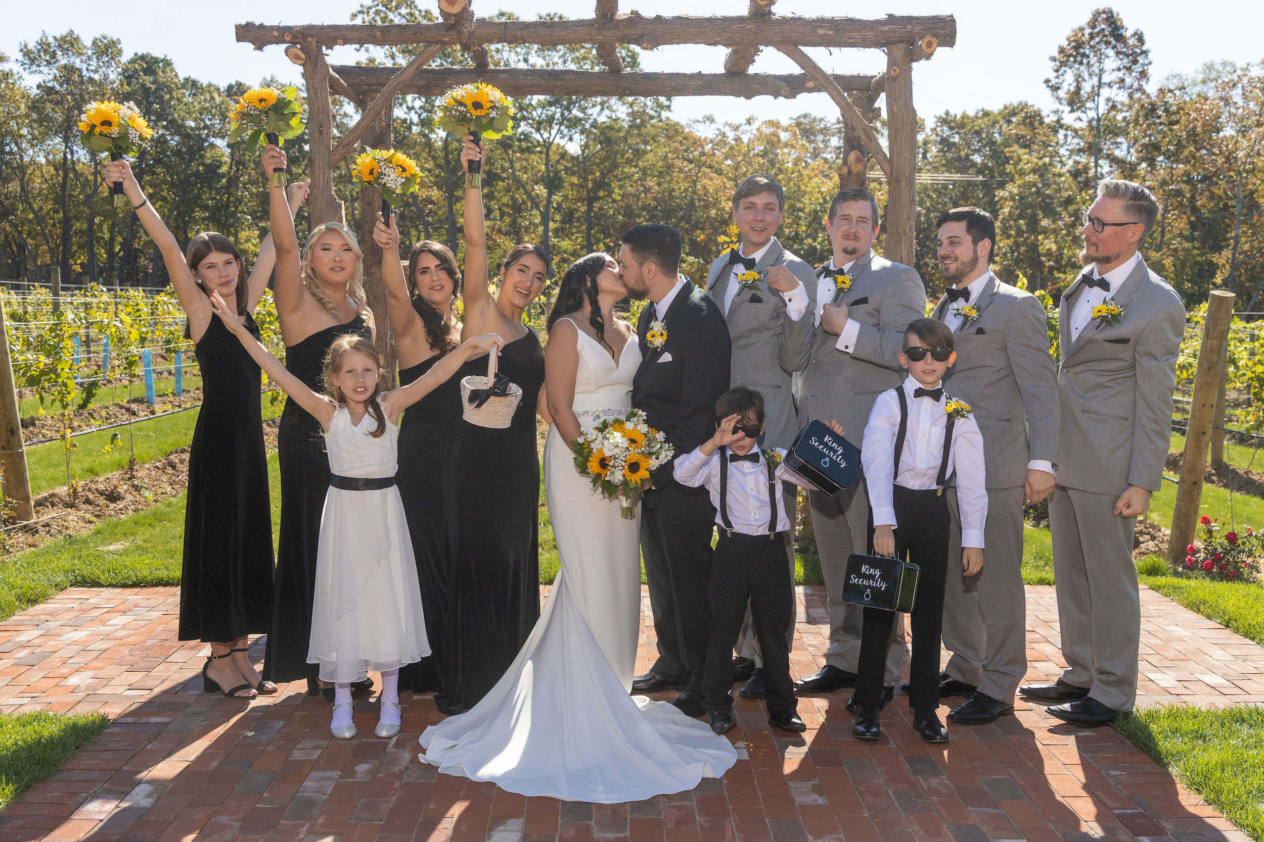 Vineyard couple kiss bridal party arbor 0535