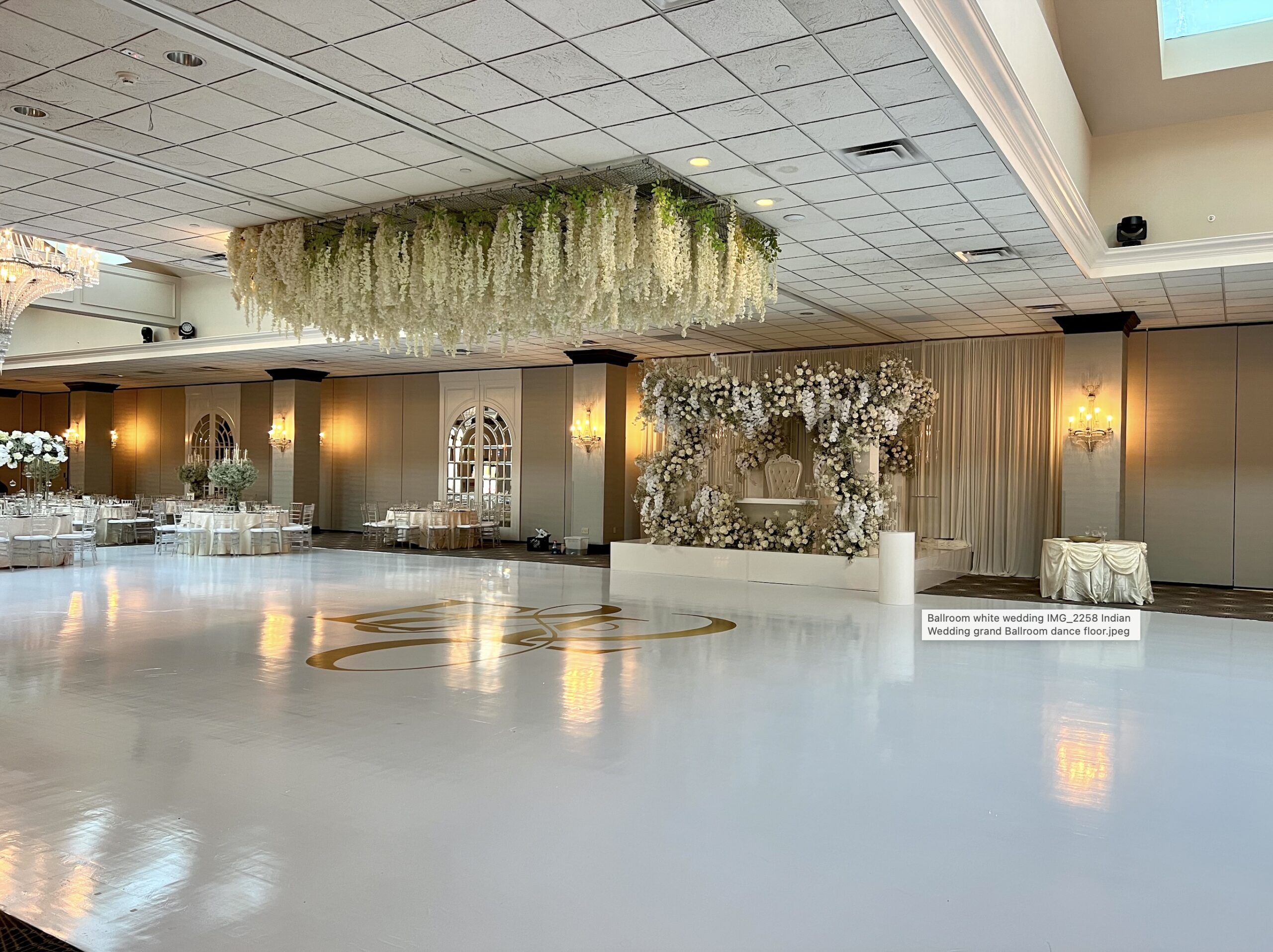 Elegant wedding ballroom with floral decorations.