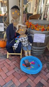 Scarecrow display with small fishing pool.