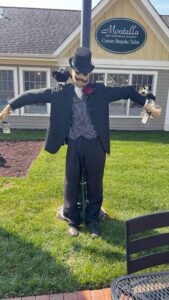 Formal scarecrow in front of tailor shop.