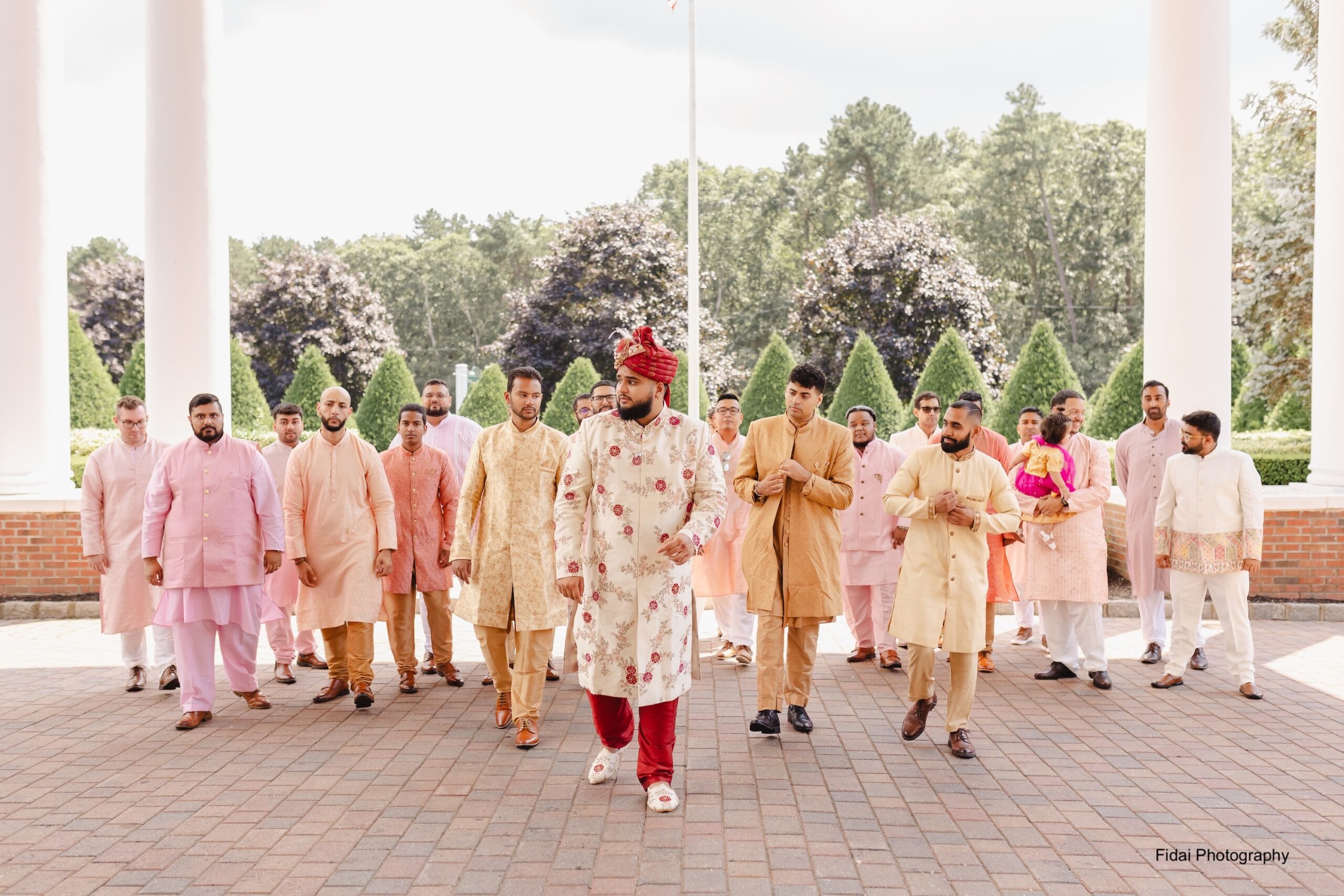 Men in traditional attire walking together outdoors.