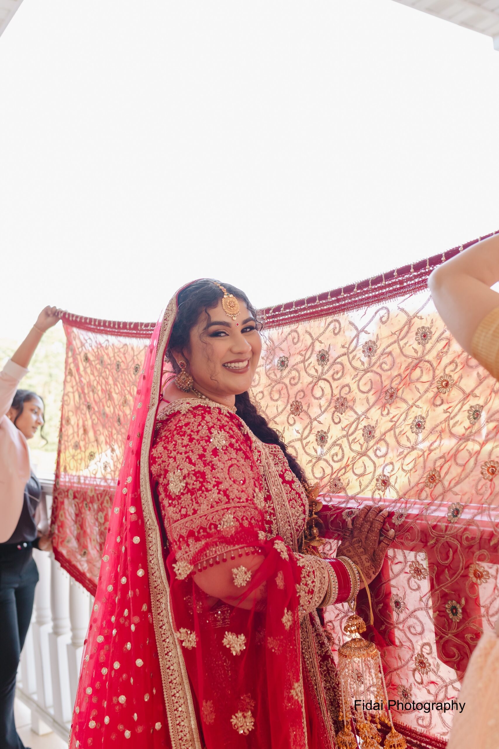 Bridal portrait in vibrant red attire.