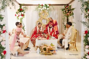 Indian wedding ceremony with vibrant decor.