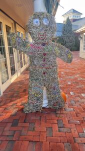 Hay figure decoration on a brick patio.