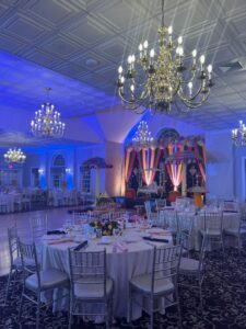 Elegant event space with chandeliers and decor.