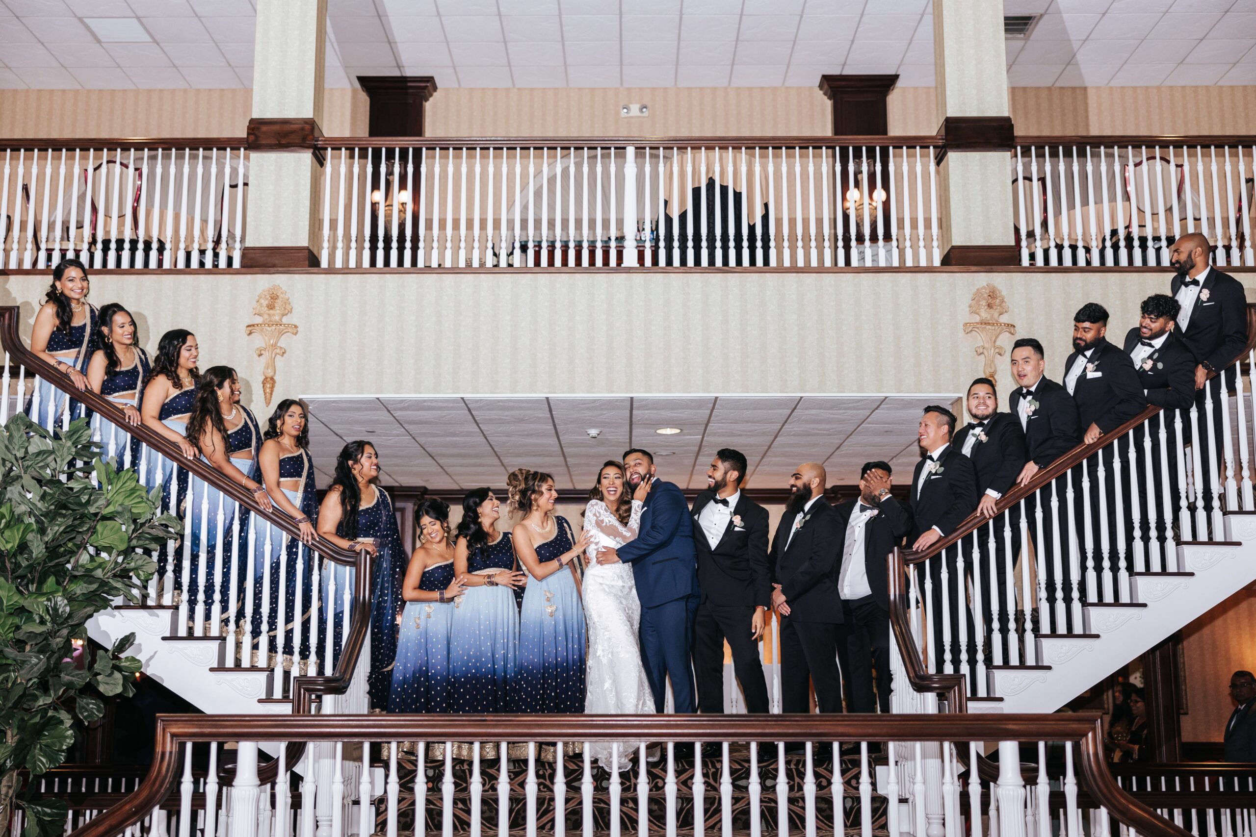 Bridal party on staircase at wedding celebration.
