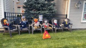 Halloween scarecrows seated in a row
