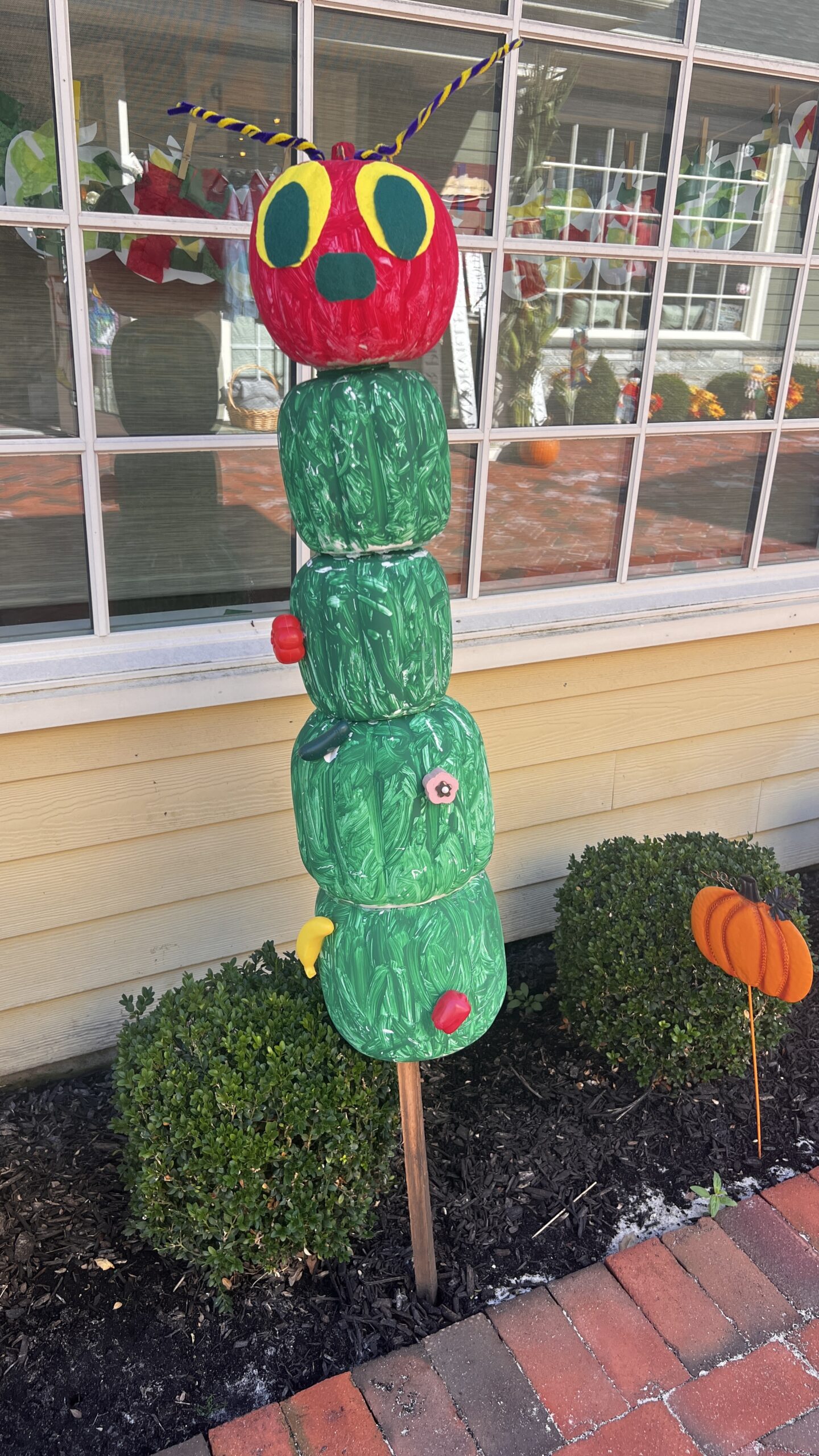 Colorful caterpillar pumpkin display.