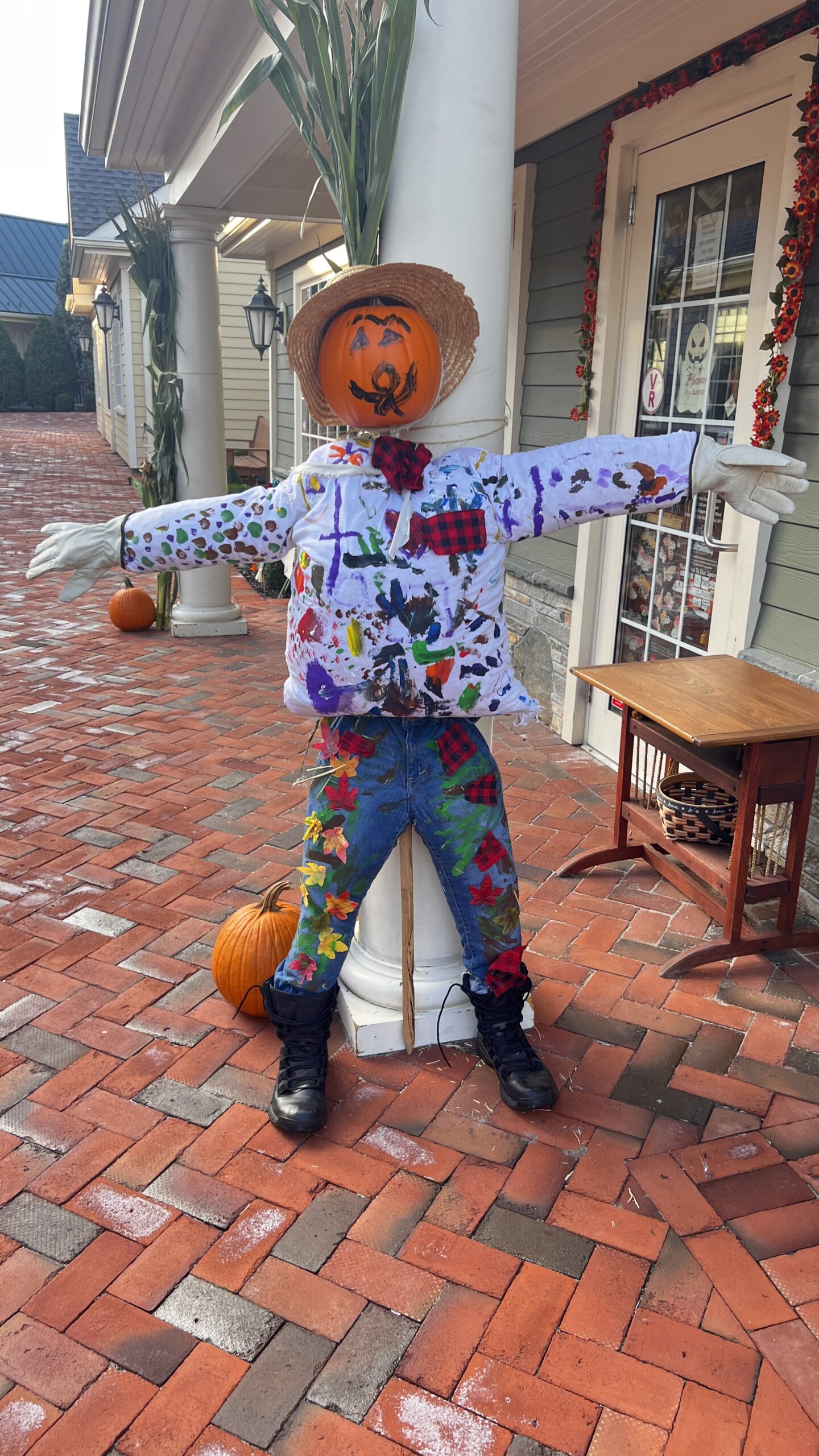 Colorful scarecrow with pumpkin head