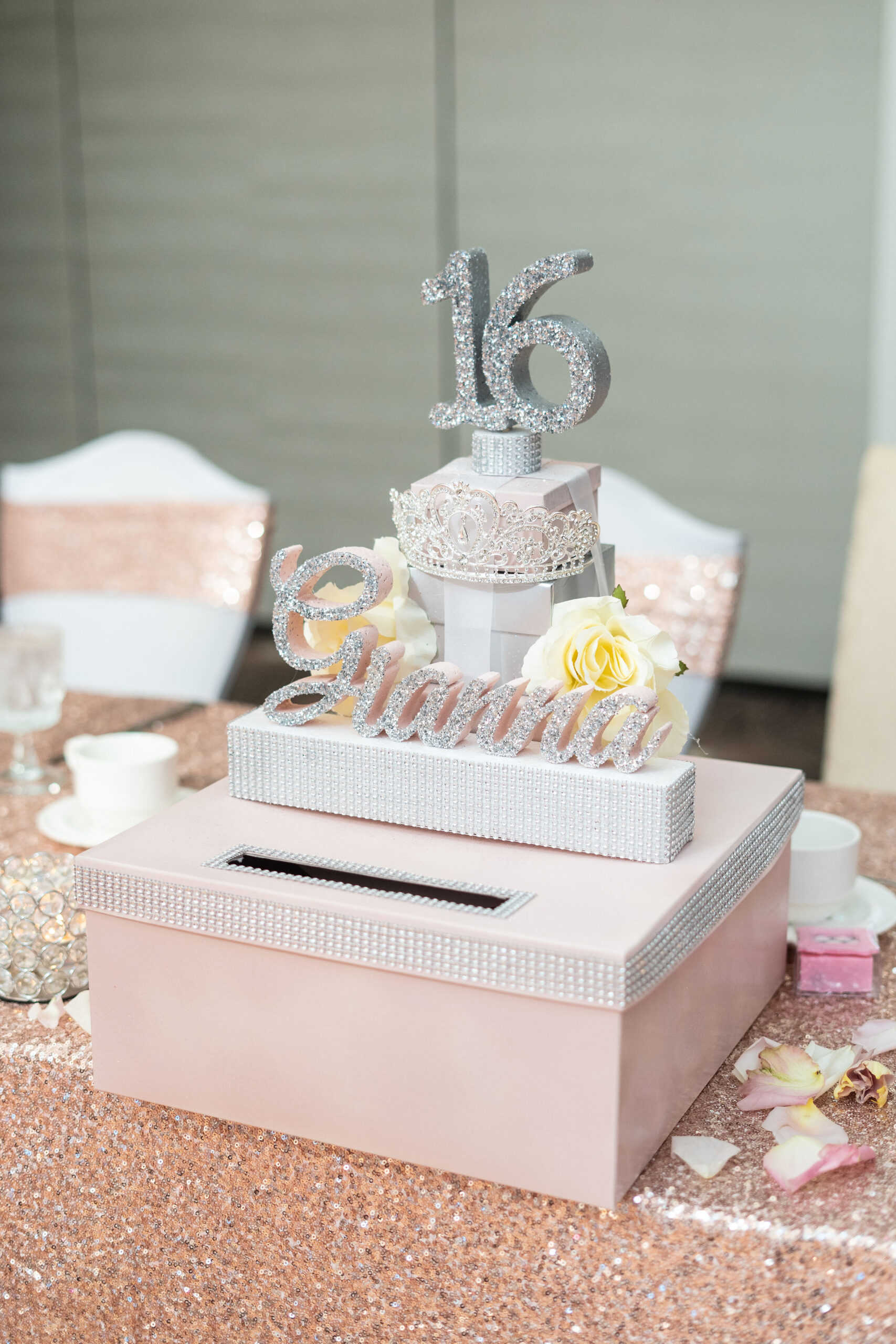 Elegant 16th birthday cake and gift box display.