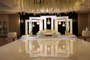 Elegant wedding stage with floral decor.