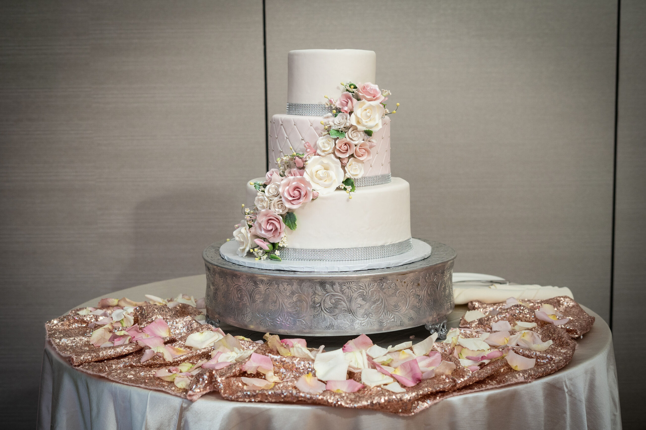 Elegant three-tier wedding cake with floral decor.
