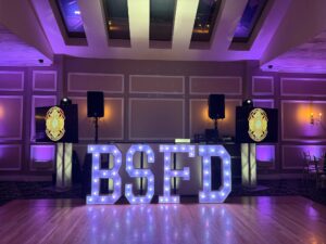 Illuminated BSFD letters on dance floor.
