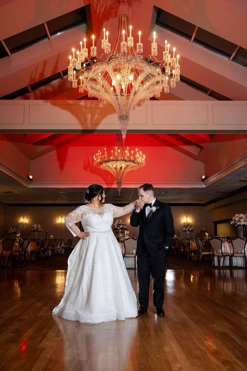 Elegant wedding dance under chandelier.