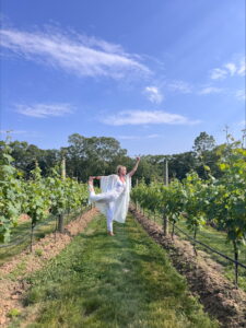 Person doing yoga in a vineyard.