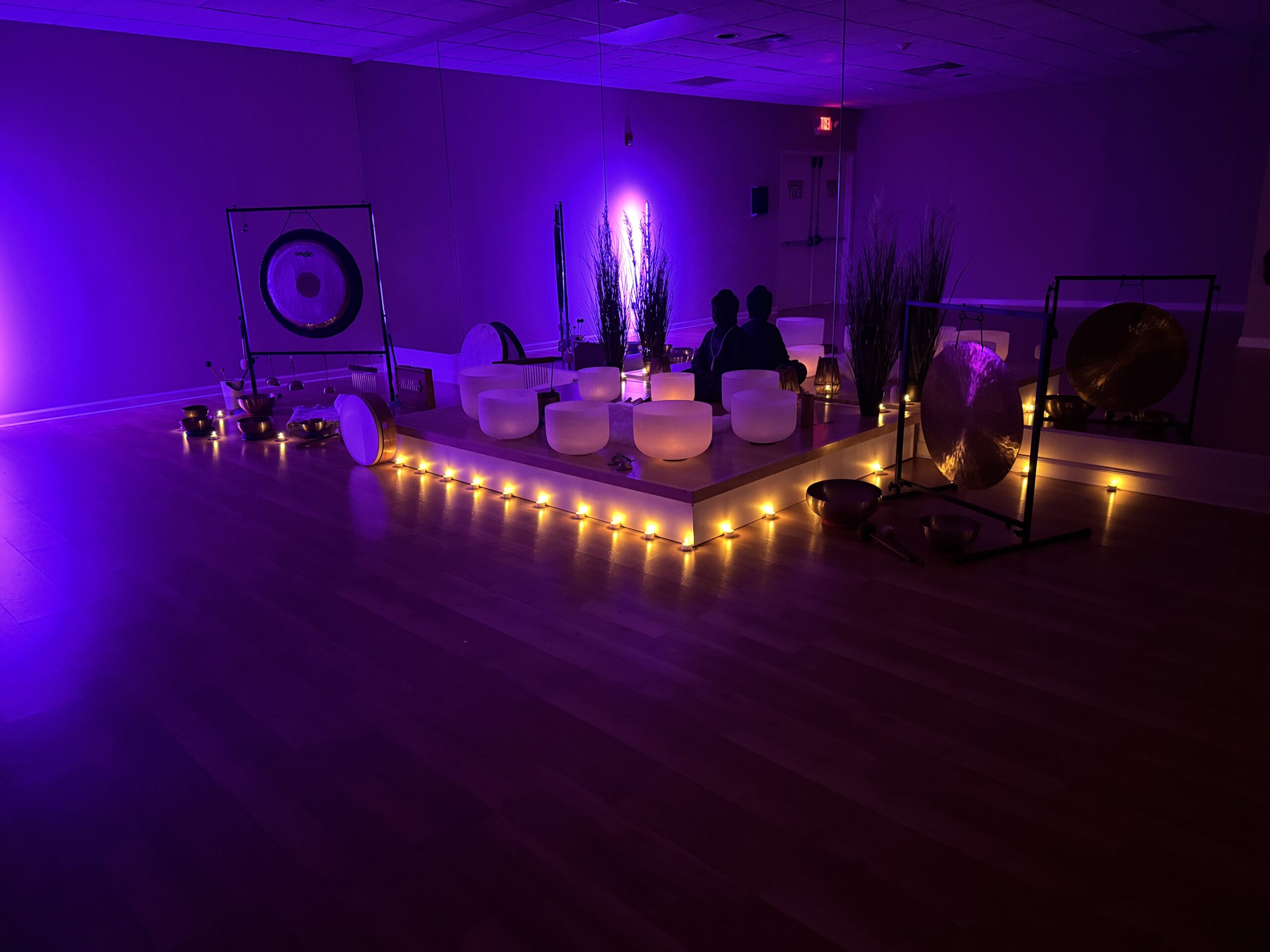 Calming meditation room with soft purple lighting.