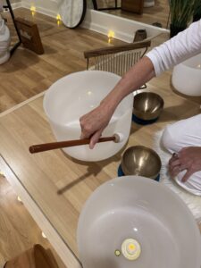 Person playing crystal singing bowls