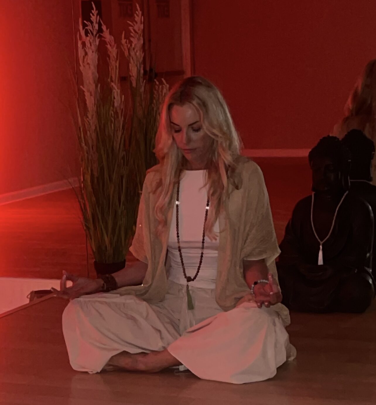 Woman meditating in tranquil red room