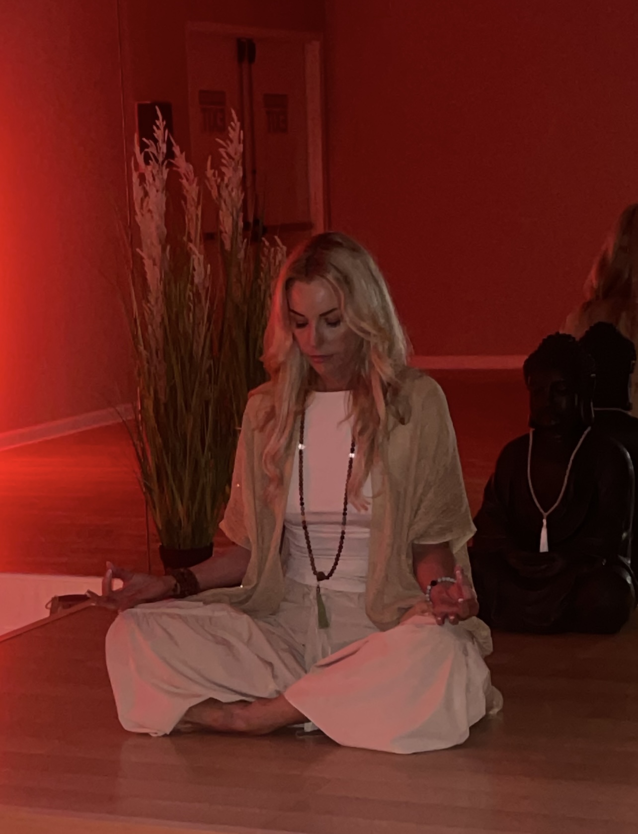 Woman meditating in tranquil red room