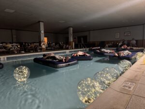 Indoor pool relaxation with floating lights.