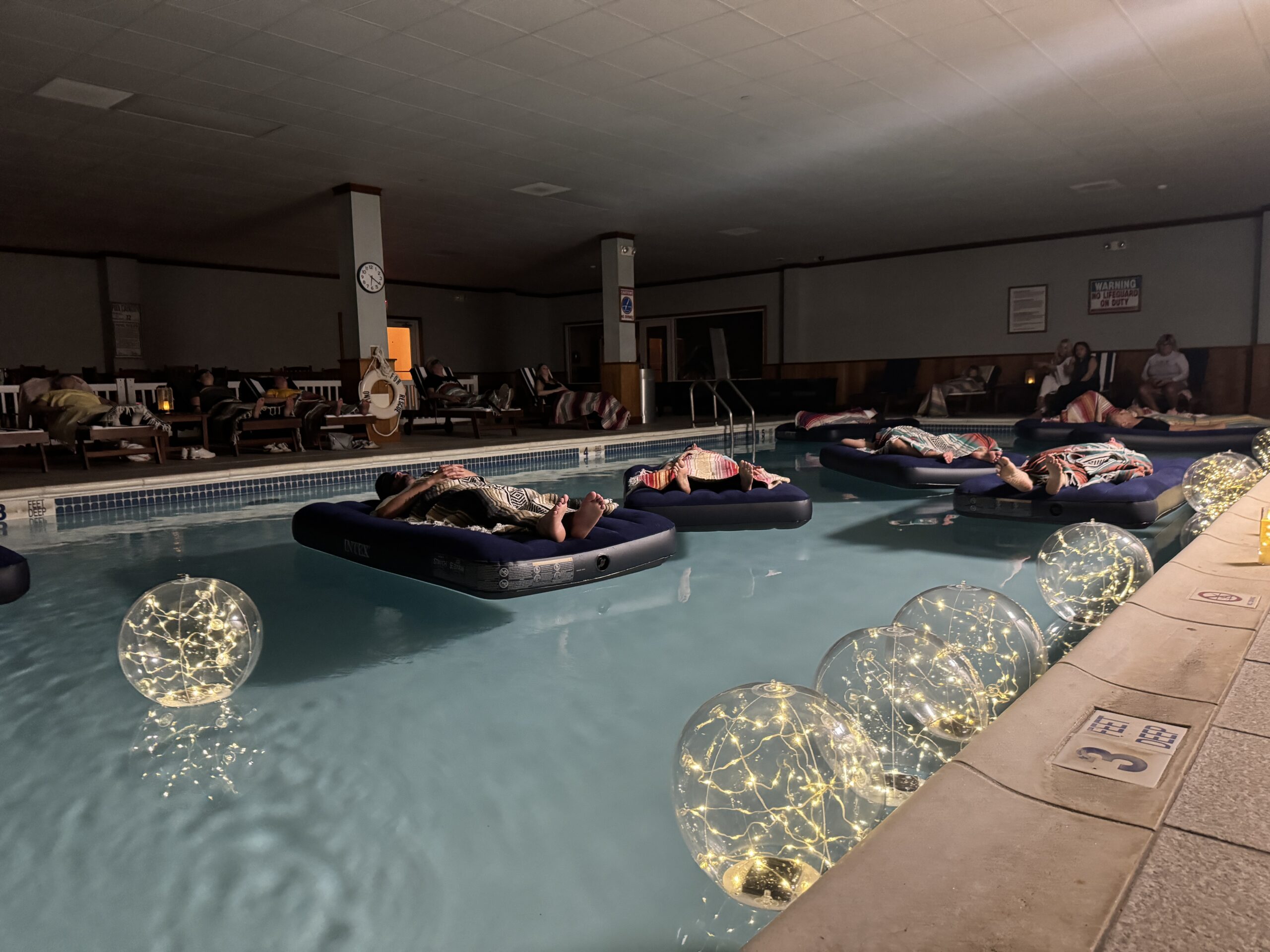 Indoor pool relaxation with floating lights.