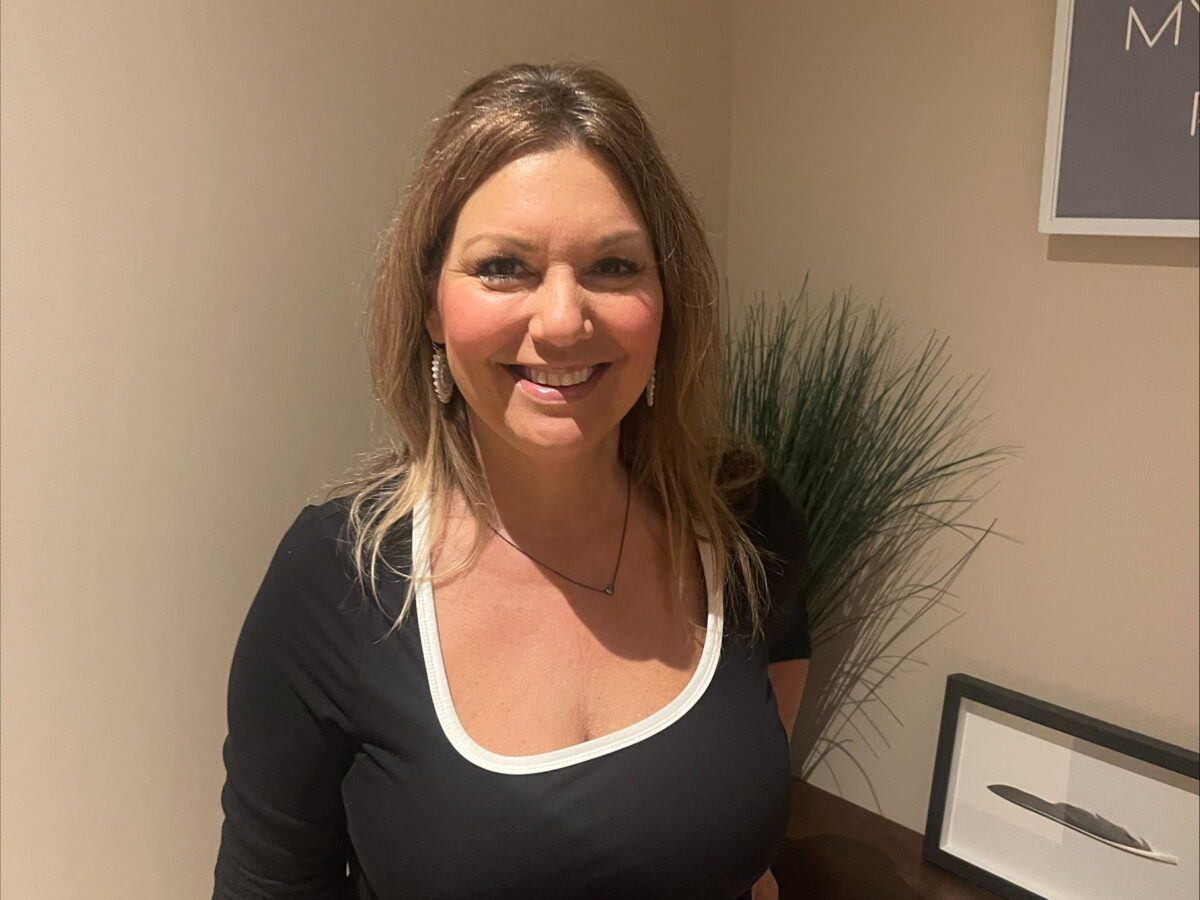 Smiling woman in a modern, stylish setting.