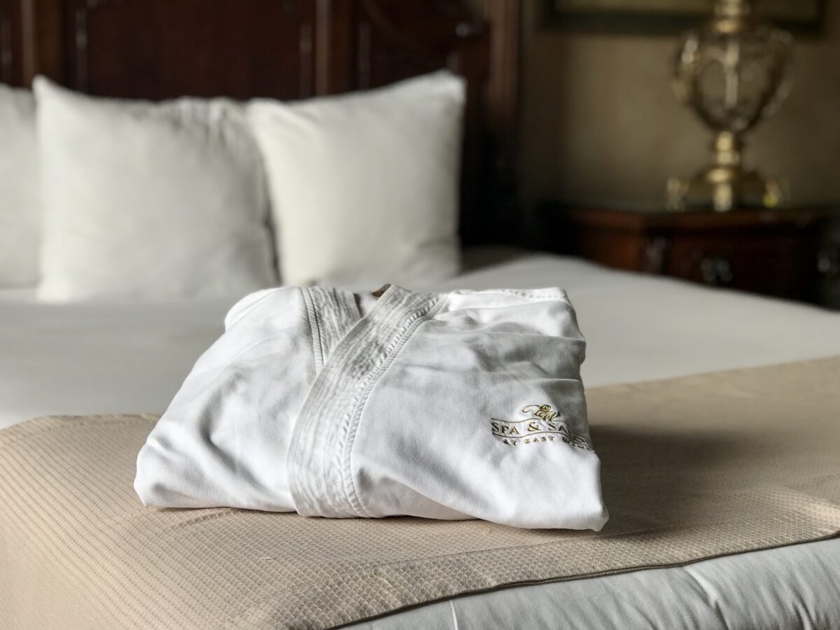 White spa robe on a hotel bed.
